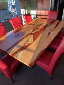 Resin river table crafted in Northern Ireland with natural wood finish